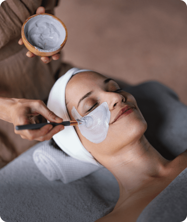 Applying clay mask at spa