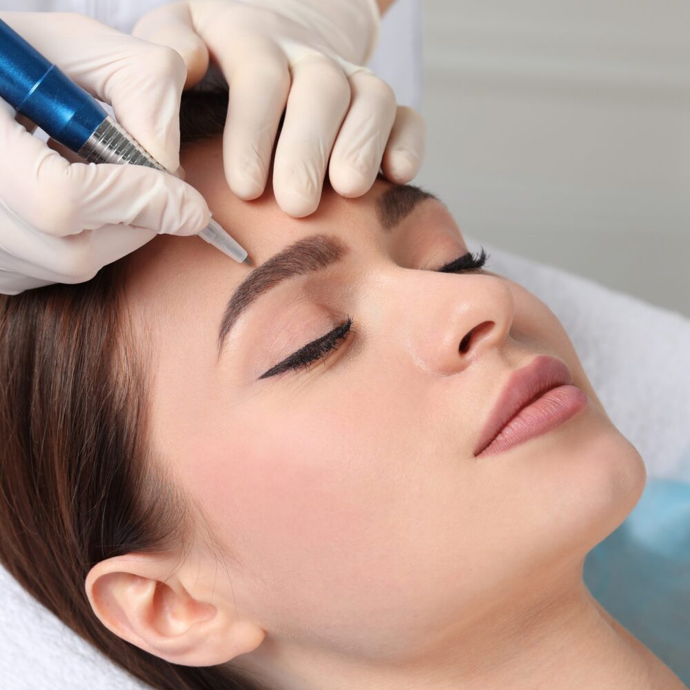Eyebrow tattooing procedure close-up