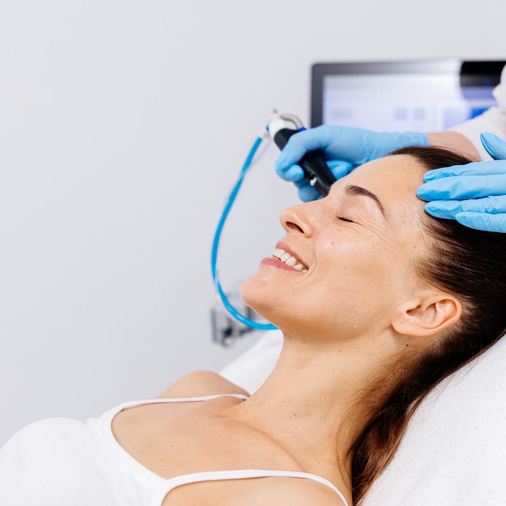 Woman receiving facial treatment at spa