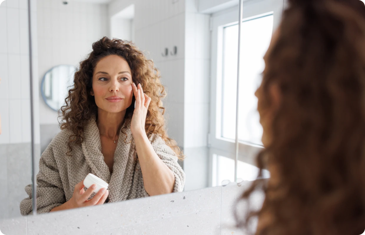 Skincare routine with curly-haired woman